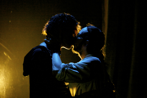 Two character are silhouetted by the light as they kiss